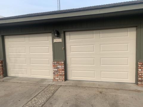 Two white CHI raised-panel garage doors installed at a Ripon home