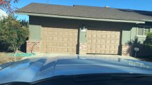 Two older brown garage doors at the Ripon home before replacement