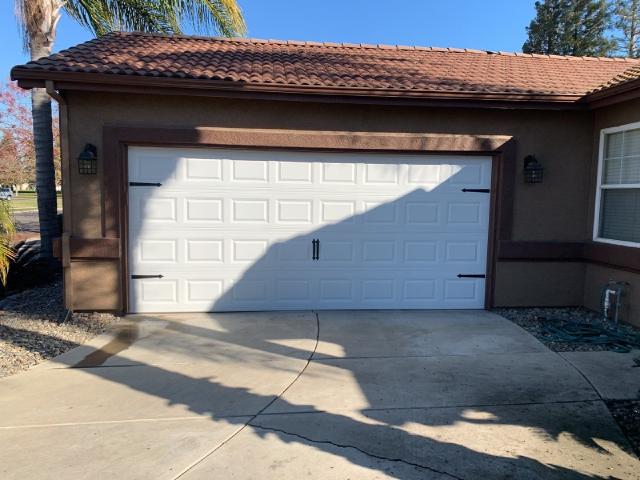 Finished white raised-panel garage door on a Turlock home