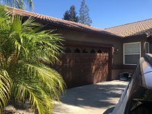 Dark brown garage door at the Turlock home before replacement