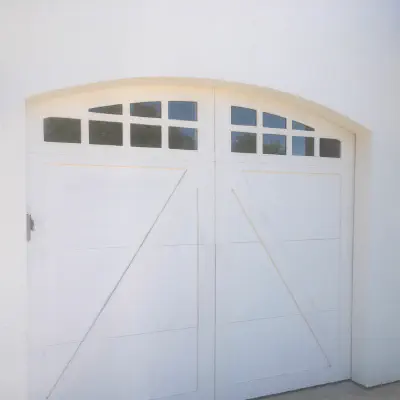 Custom arched white carriage-house garage door