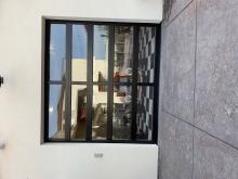 A black full view door with an old car behind it.