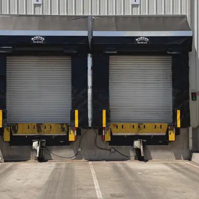 Two Marvel truck shelters with rain diverters installed at loading bays in Ballico