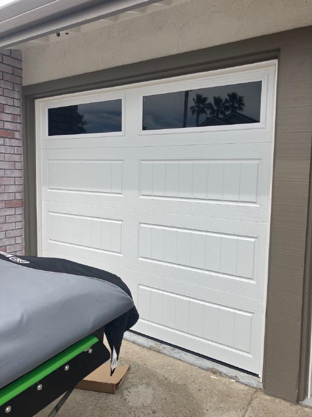 White garage door with two rectangular top windows on a Discovery Bay home