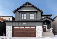 CHI Skyline Flush garage door in Dark Oak woodtone on a snowy driveway