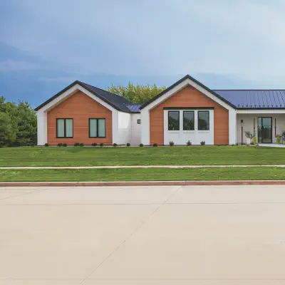 Black CHI Skyline Flush garage door with stacked obscure windows on a modern white-and-wood exterior