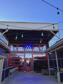 Red-framed CHI full-view glass doors enclosing a restaurant patio