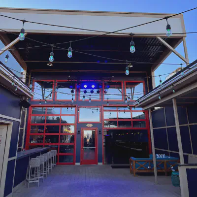 Red-framed CHI full-view glass doors enclosing a restaurant patio