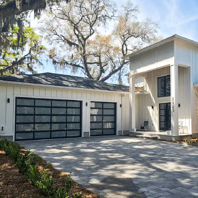 CHI full-view glass garage doors on a modern residential exterior