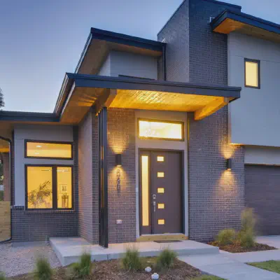 Dark-finish CHI Planks garage door on a contemporary home at dusk