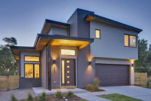 Dark-finish CHI Planks garage door on a contemporary home at dusk