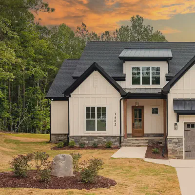 Driftwood CHI Stamped Carriage House garage door with windows on a modern farmhouse