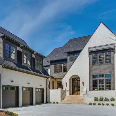 Graphite CHI Stamped Carriage House garage doors with windows on a large white estate