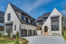 Graphite CHI Stamped Carriage House garage doors with windows on a large white estate