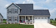 White C.H.I. stamped carriage house garage door with arched Stockton windows and decorative hardware