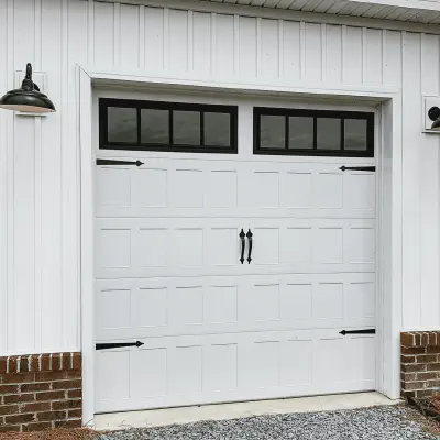 White CHI Stamped Shaker garage door with top-row windows and decorative black hardware