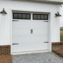 White CHI Stamped Shaker garage door with top-row windows and decorative black hardware