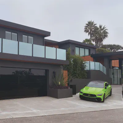 Black all-glass CHI Sterling garage doors on a modern home with a rooftop terrace